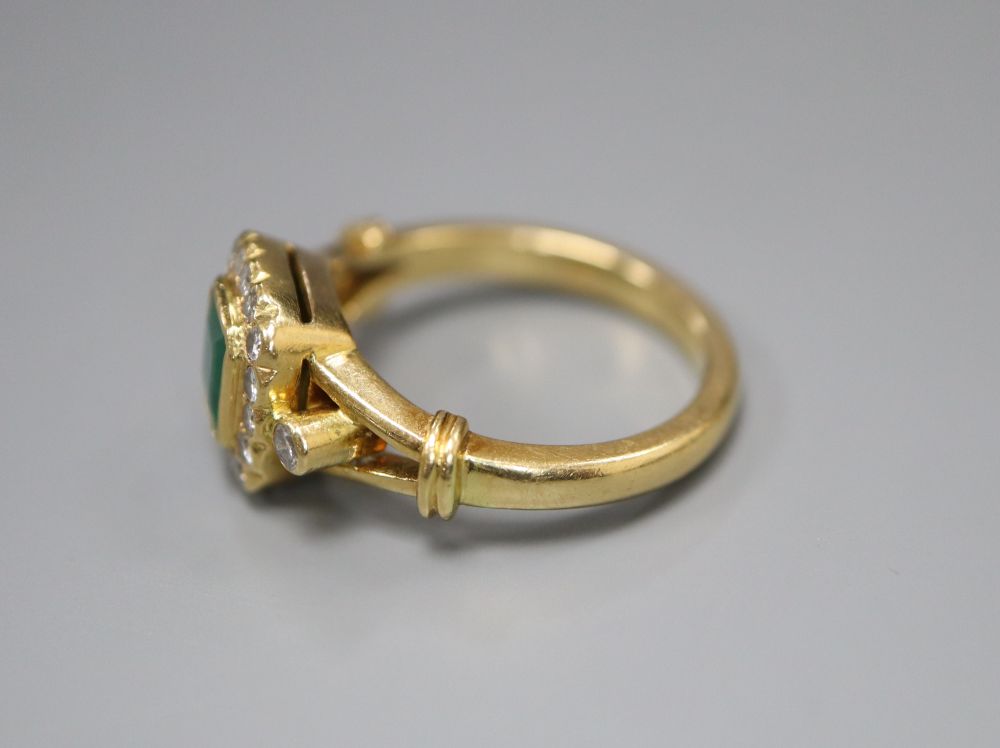 A modern 18ct gold, emerald and diamond cluster ring, size N, gross 6.6 grams.